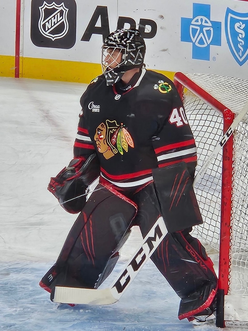 David Nozzolillo in full Blackhawks goalie gear, wearing number 40, stands in front of the net at the United Center.
