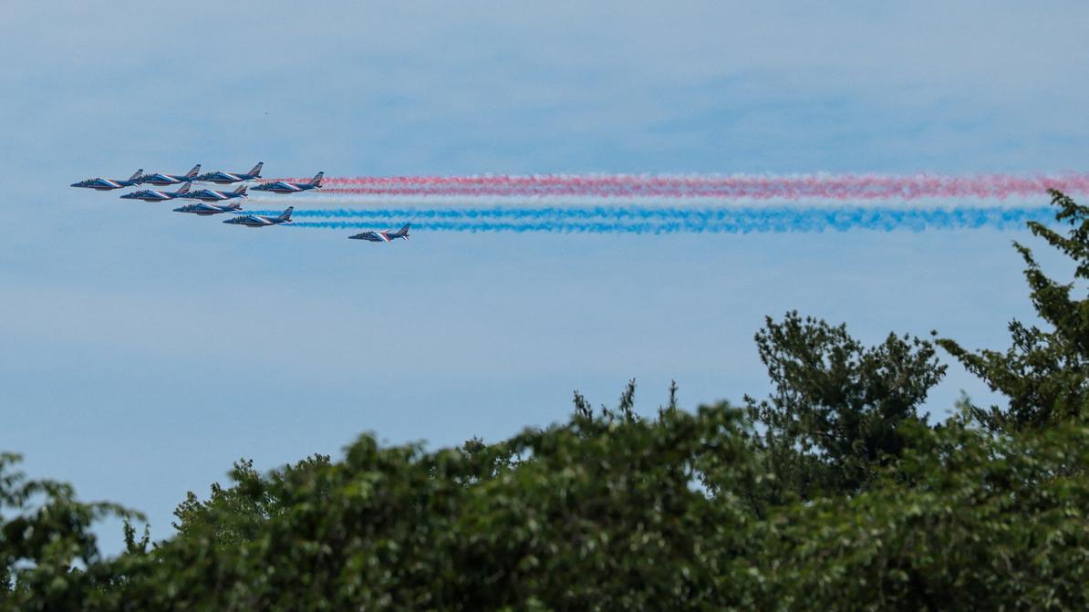 French air force flyover with red, white, and blue smoke trails